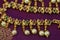 antique stone studded gold jewelry necklace on a lovely purple silk fabric