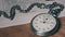 Antique Stopwatch Lies on Wooden Desk with Old Documents and Counts Seconds