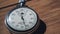 An Antique Stopwatch Lies on Wooden Table and Counts the Seconds, Timelapse