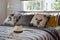 Antique straw hat on black and white patterned bed at home