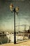 Antique street lamp with yacht and vintage style texture overlaid effect