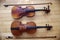 Antique string violins on wood floor background