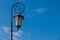 Antique style lampposts against a bright blue sky