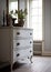 Antique style white chest of drawers in sunlit classic room, created using generative ai technology