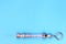 Antique syringe made of metal and glass on a blue background. free space for text. copyspace