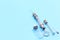 Antique syringe made of metal and glass on blue background. free space for text. copyspace