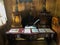 Antique table with feather, documents and inkwell. Vintage inkwell and fountain pen on a table with old letters.