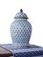 Antique Thai porcelain jar placed on a table covered with cotton on white background