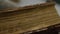Antique thick book edge with thorn yellowed pages in library