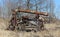 Antique threshing machine rusting in the weeds