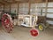 Antique tractors in an old barn