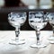 Antique transparent glass set of wine glasses in luxury interior. crystal glass with engraving.