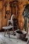 An antique treadle style grinding wheel in a barn.