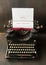 antique typewriter with christmas greetings on wooden background