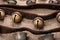 Antique vintage oxidize brass sleigh bells on leather strap and burlap