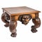 Antique vintage retro coffee wooden table with muzzle and paws of a lion, close-up