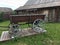 Antique vintage Russian rural peasant cart in the yard of a wooden house