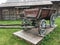 Antique vintage Russian rural peasant cart in the yard of a wooden house