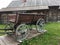 Antique vintage Russian rural peasant cart in the yard of a wooden house