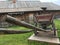 Antique vintage Russian rural peasant cart in the yard of a wooden house
