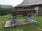 Antique vintage Russian rural peasant cart in the yard of a wooden house