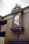 Antique wall clock with pendulum against wooden background.