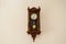 Antique wall clock with a pendulum from wood