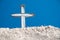 Antique white cross on adobe building in New Mexico