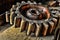 Antique Wood Machinery Wheel on Old Wooden Bench