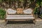 Antique wood and metallic decorated bench at a park. Golden decorated ornaments.