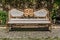 Antique wood and metallic decorated bench at a park. Golden decorated ornaments.