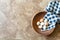 Antique wooden bowl with blue and white gingham towel