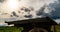 Antique wooden cart standing alone in a field, beautiful autumn landscape, hyperlapse, time lapse, heavy autumn sky