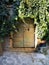 Antique wooden door with a brick arch layout at Civita di Bagnoregio,Italy.