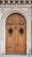 Antique wooden door with carved stone structure in an ancient pa