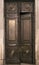 Antique wooden massive half opened door with carved wooden ornament