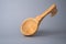 Antique wooden spoon on a gray studio background. Carved wooden scoop. Old wooden utensils for eating soup. Empty ladle