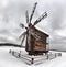 Antique wooden windmill in snowy ukrainian village. Winter landscape
