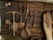Antique yard tools hang on the outer wall of a shed