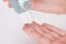 Antiseptic gel in a bottle spilling out onto fingers.Close up.Soft focus.Hands holding a blue vial.Concept of health protection,