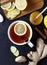 Antiviral ginger tea with lemon and honey on dark background. Top view. Useful Healthy drink