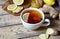 Antiviral ginger tea with lemon and honey on wooden background. Healthy drink. Rustic style. Creative composition.