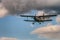 Antonov AN-2 biplane in the skies with clouds