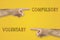 Antonym concept. Hands pointing to different sides. Voluntary or compulsory on yellow background.