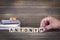 Antonym. wooden letters on the office desk