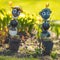 Ants, garden toys. A pair of large decorative metal ornaments on a flower bed