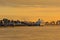 Antwerp skyline with ferris wheel and ferryboat in evening sunlight