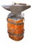 Anvil on a brown pedestal with a hammer isolated over white