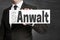 Anwalt in german Attorney shield is held by businessman