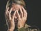 Anxiety, depression and soldier woman crying on dark studio background. Mental health, psychology and stress portrait of